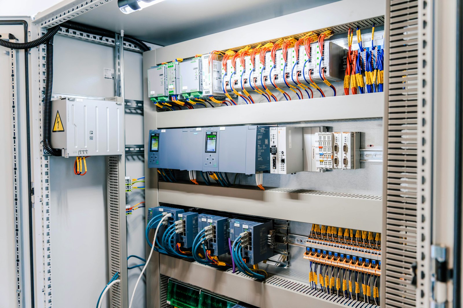 Open industrial control cabinet with terminal blocks and wiring